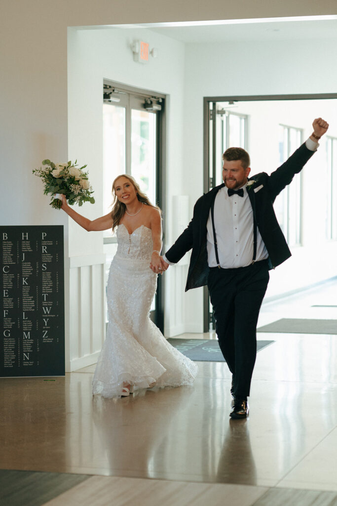 bride and groom entering their timeless wedding reception