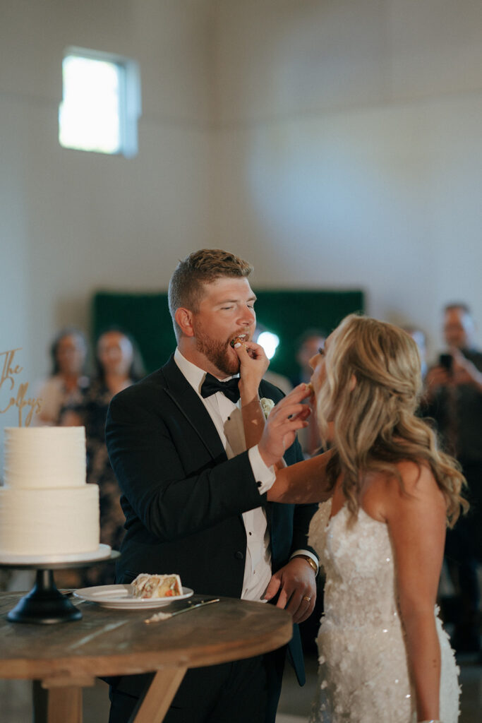 bride and groom trying their wedding cake