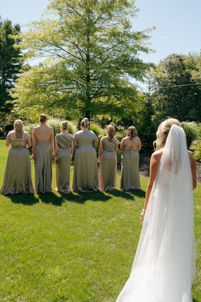 bride and her bridesmaids first look