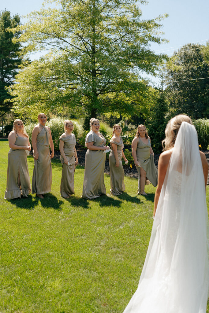 cute picture of the bride and her bridesmaids at their first look