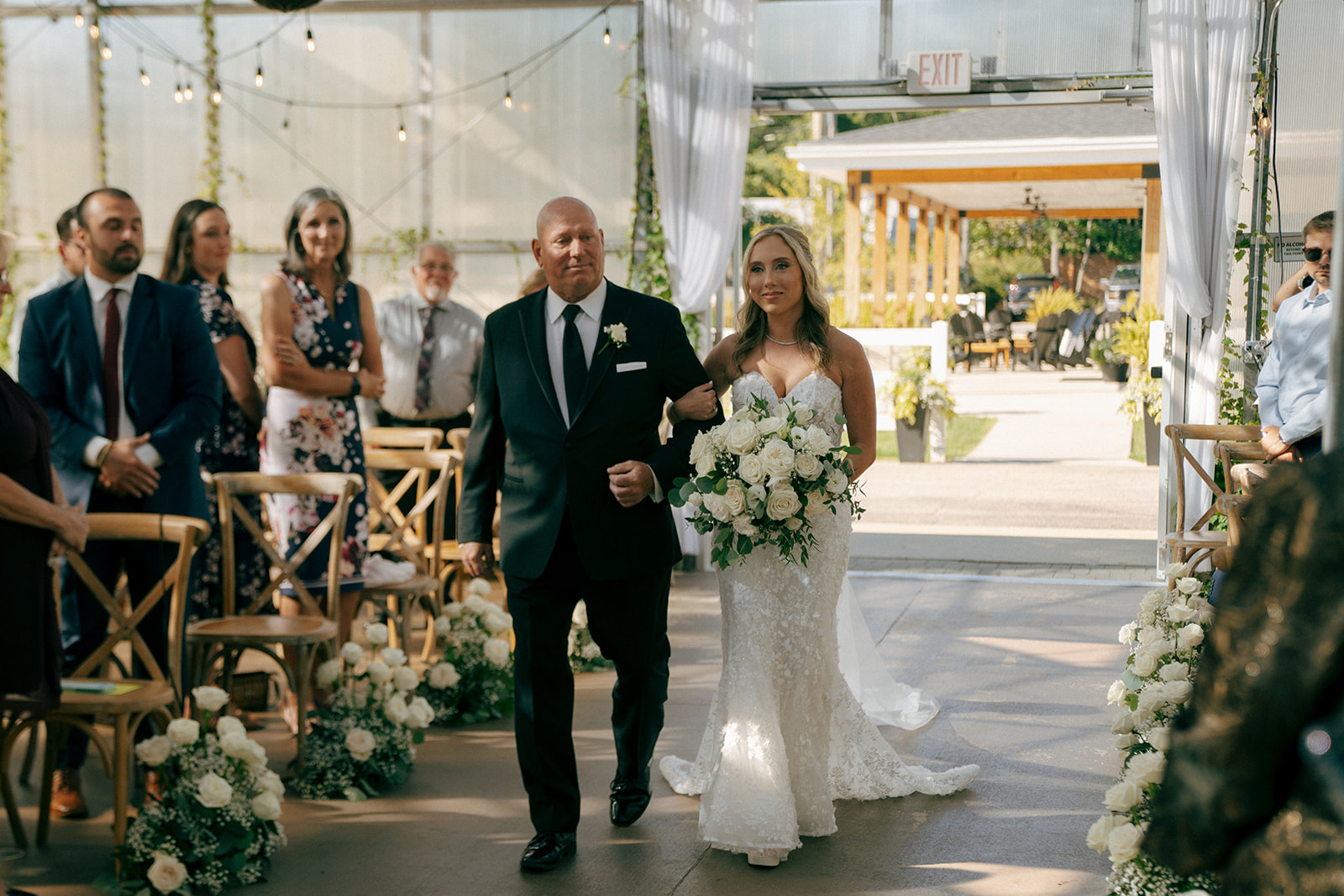 stunning bride walking down the aisle at her timeless wedding ceremony