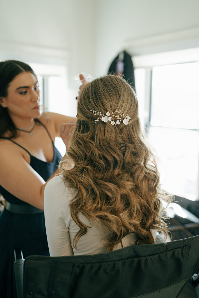 bride getting her hair done for her ceremony