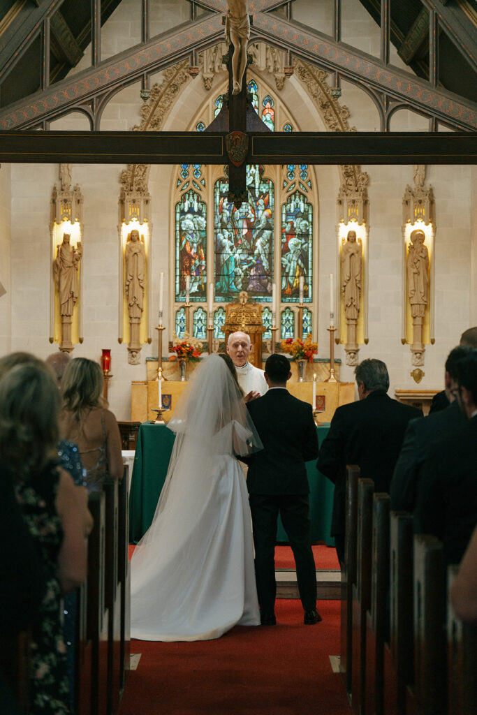 bride and groom holding hands at the ceremony