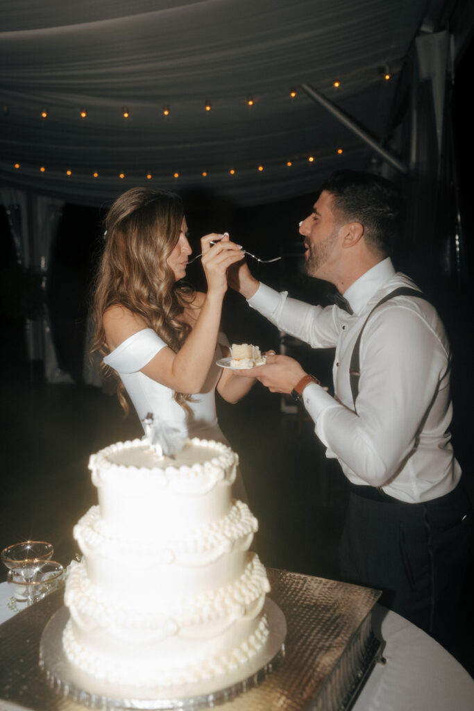 happy couple trying their wedding cake