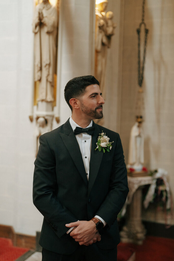 groom watching the bride walk down the aisle