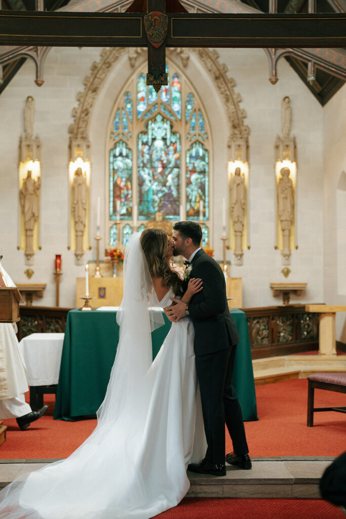 bride and groom kissing after their wedding ceremony