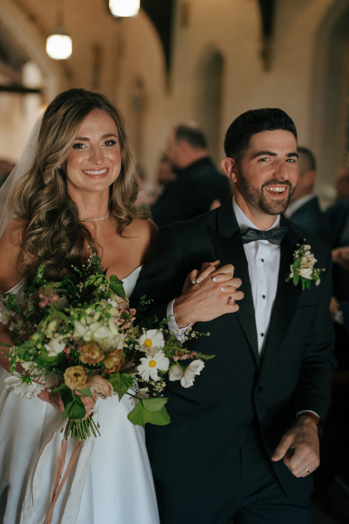 bride and groom smiling at the camera