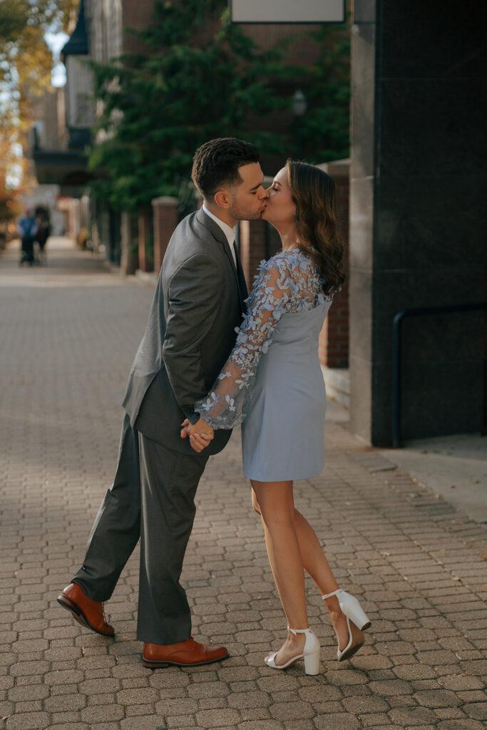 couple kissing at their colorful fall engagement session