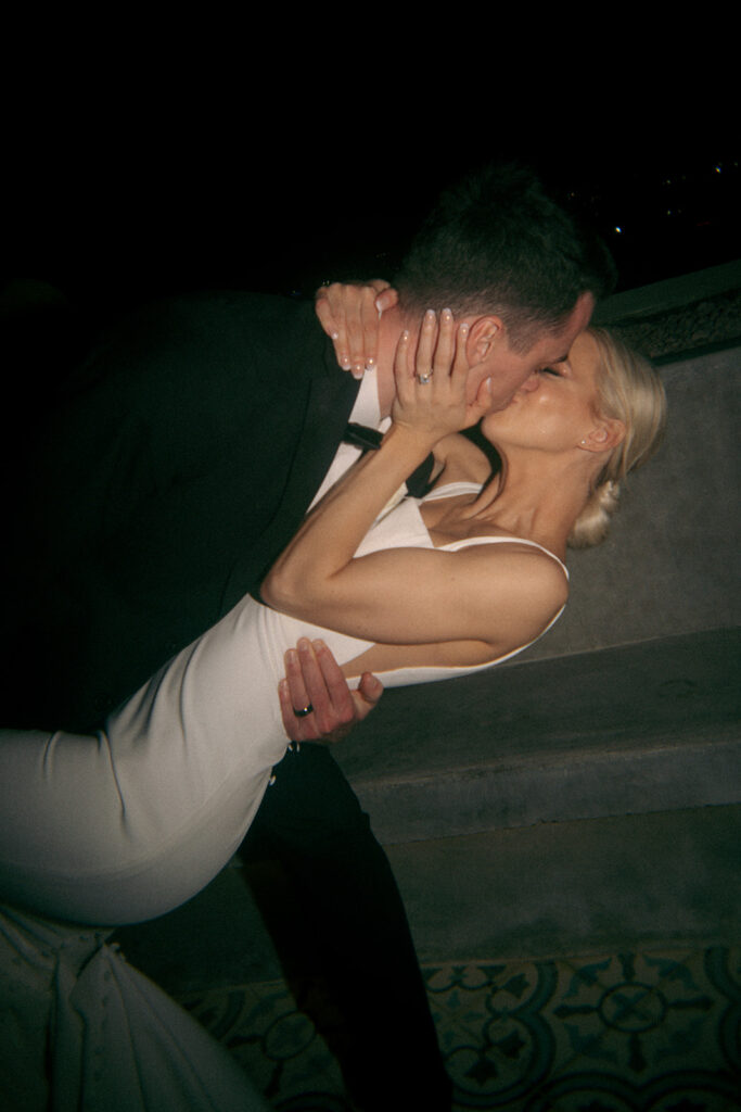 bride and groom kissing at their reception party