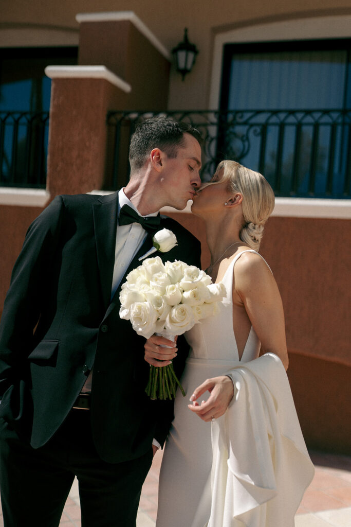 cute couple kissing during their bridal portraits