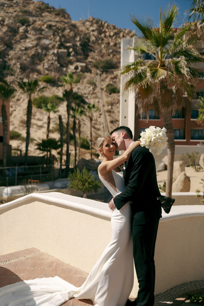 groom kissing the bride on the cheek