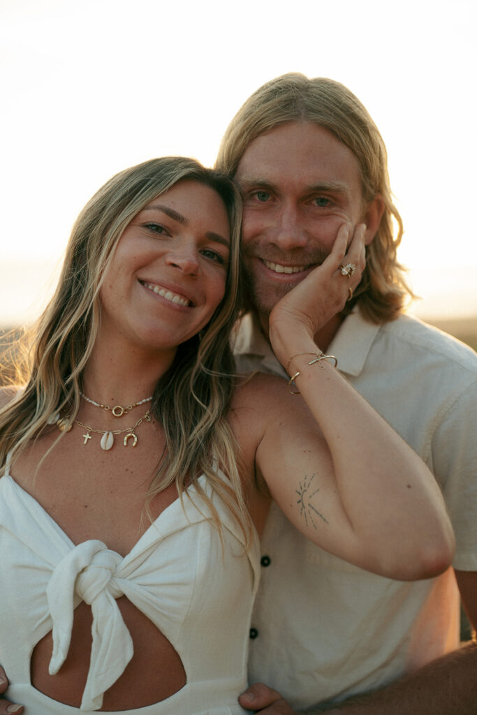 cute couple smiling at the camera during their session