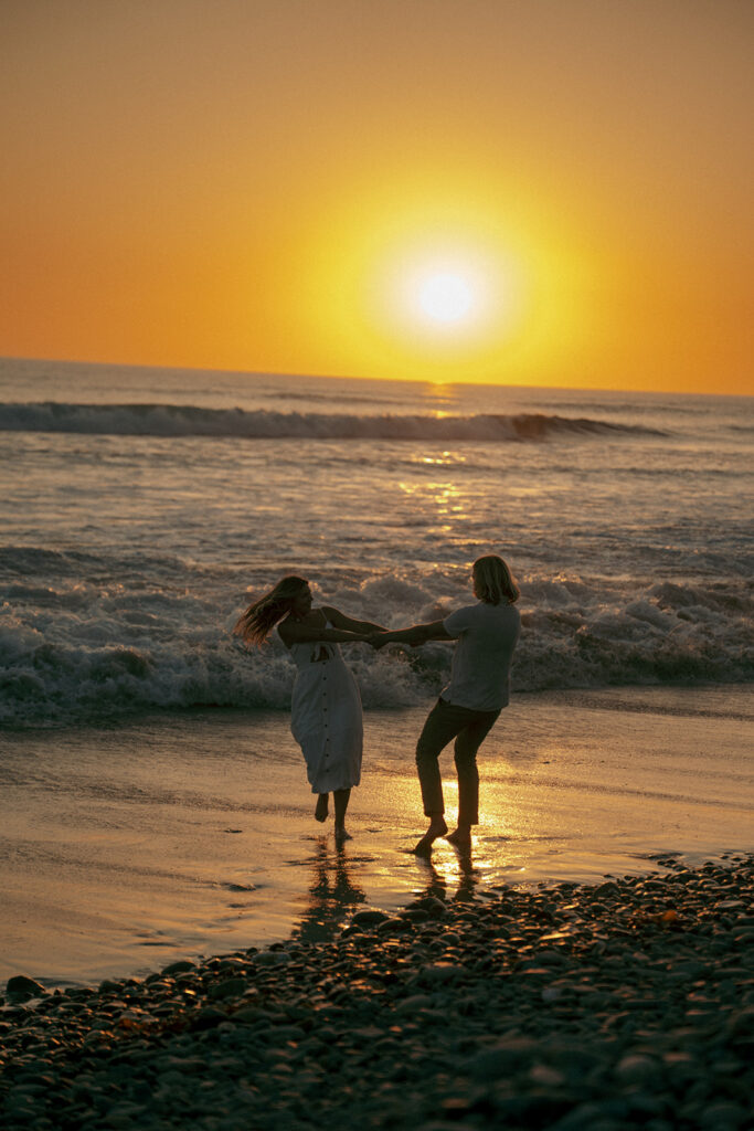 couple dancing at the beach during their session