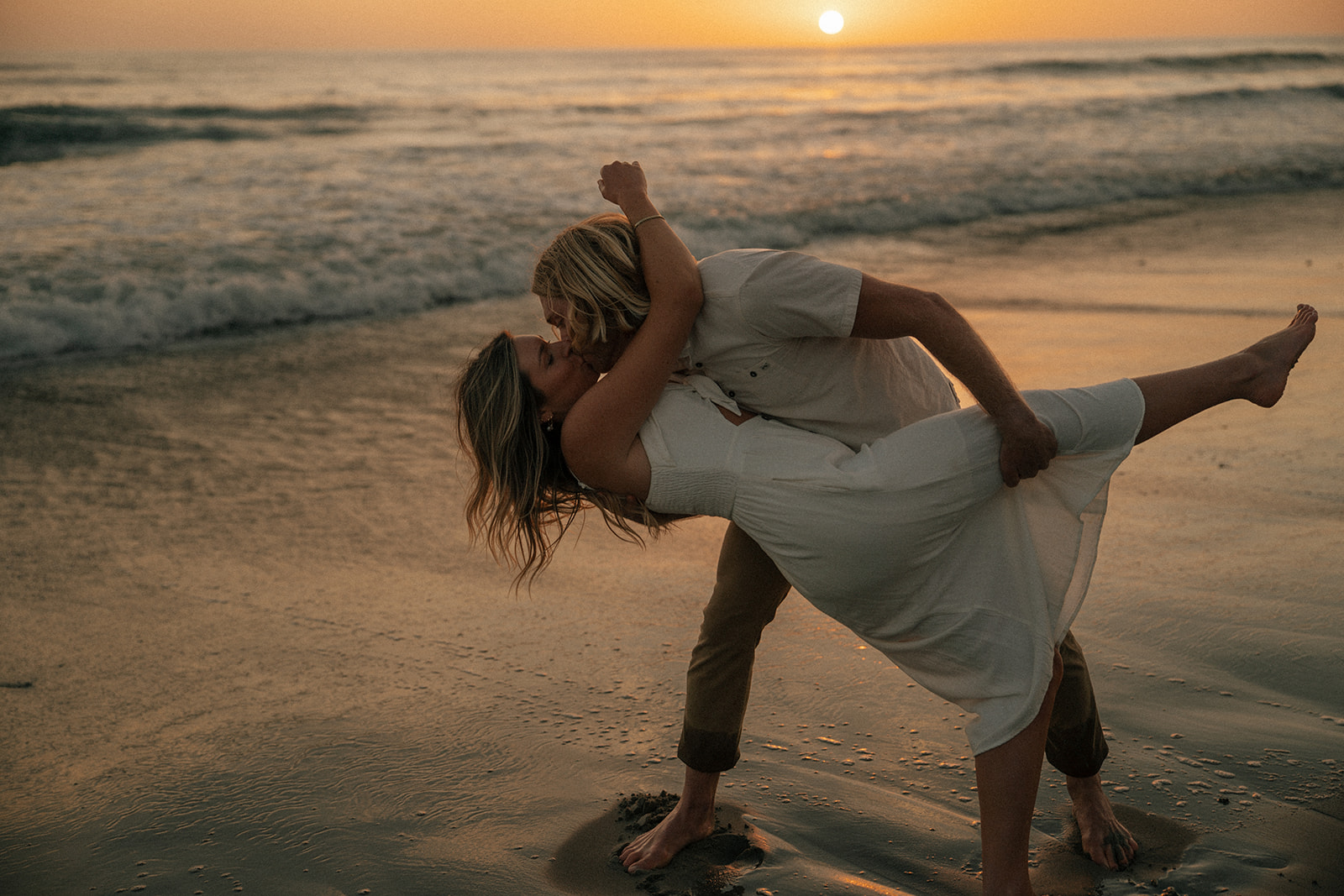 cute picture of the couple kissing during golden hour