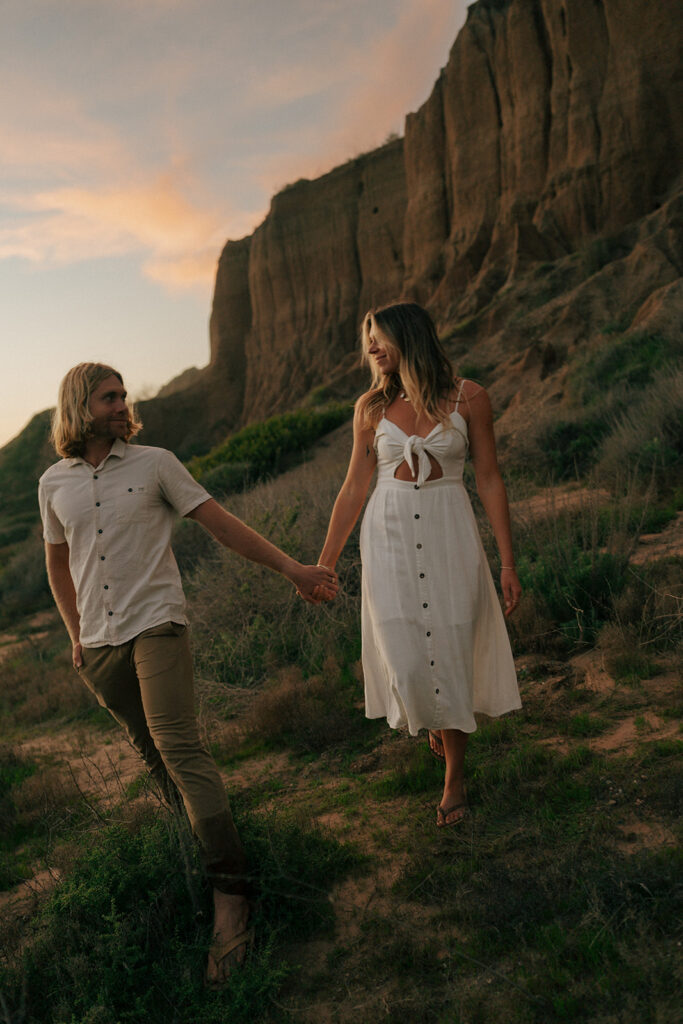 cute couple smiling with each other during their session