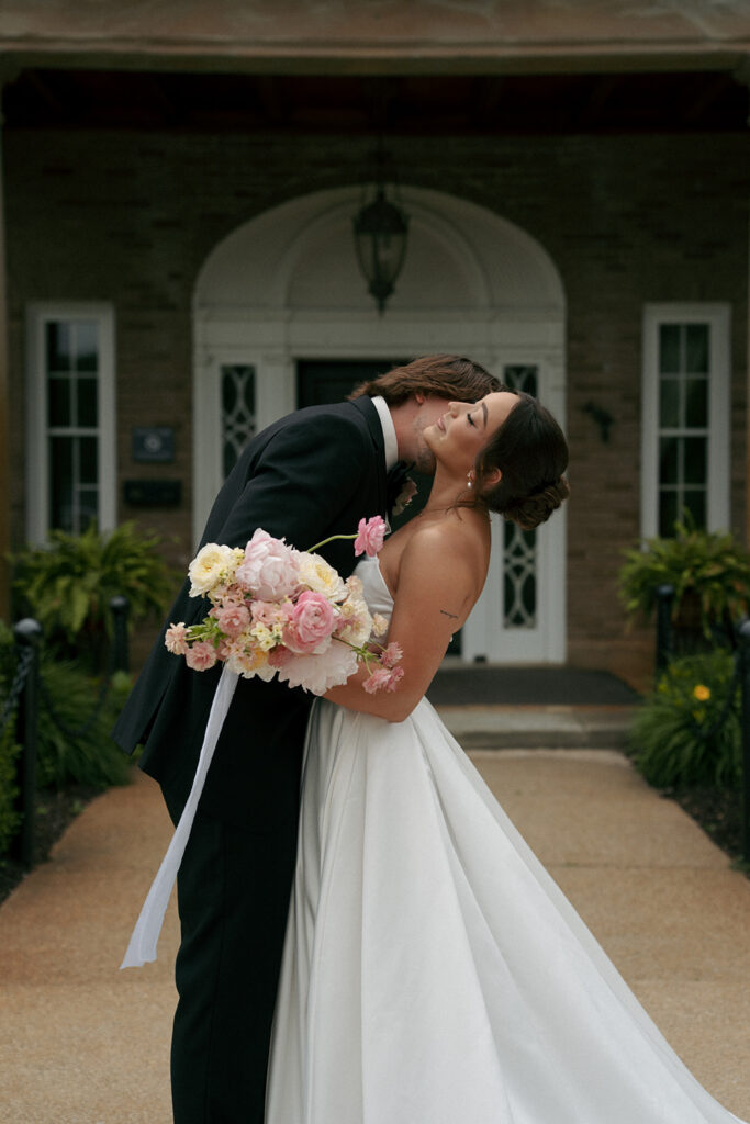groom kissing the bride on the neck