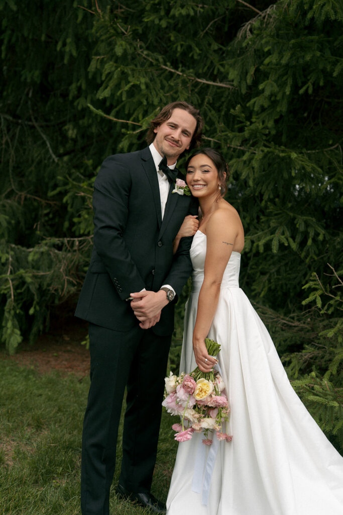 couple smiling at the camera during their bridal portraits