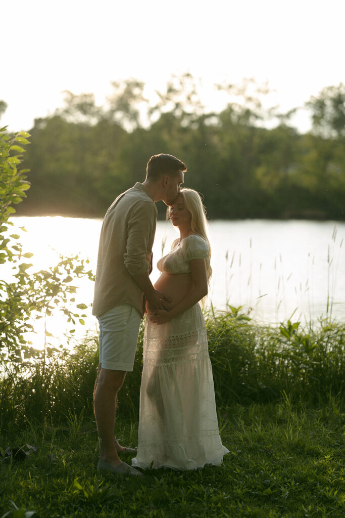 husband kissing his wife on the forehead
