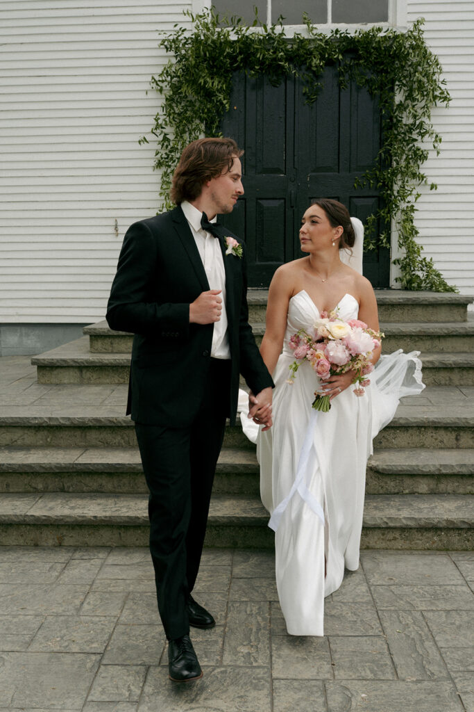 cute couple holding hands and smiling at each other during their photoshoot