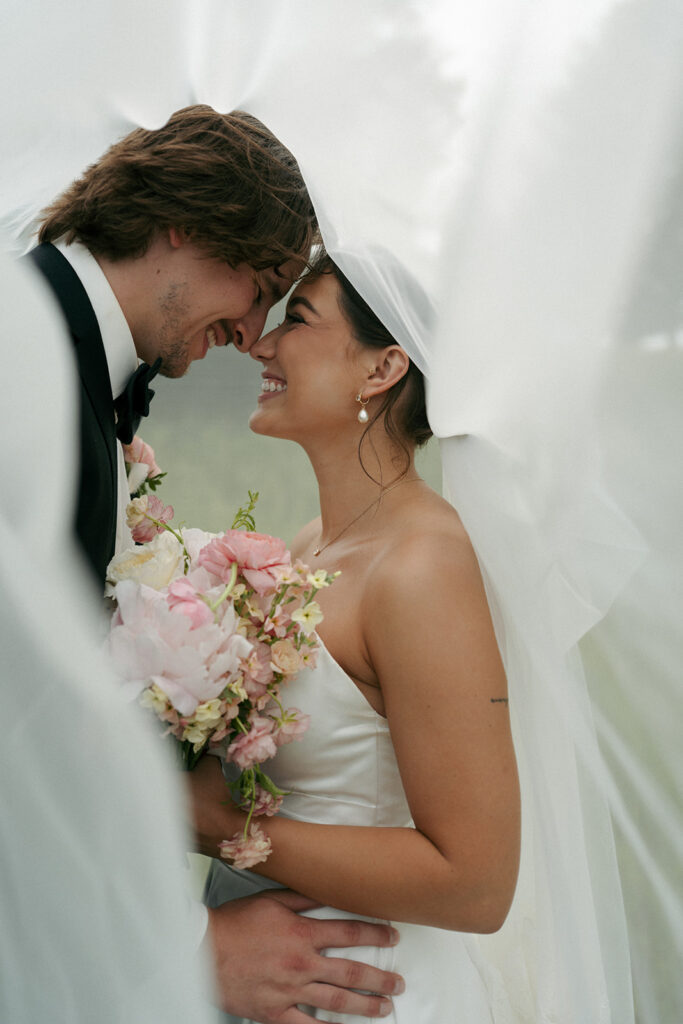 couple smiling to each other during their session