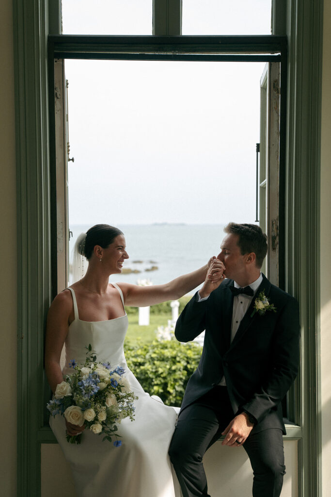 groom kissing the brides hand