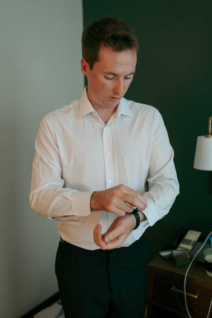 Groom getting ready before his first look with the bride