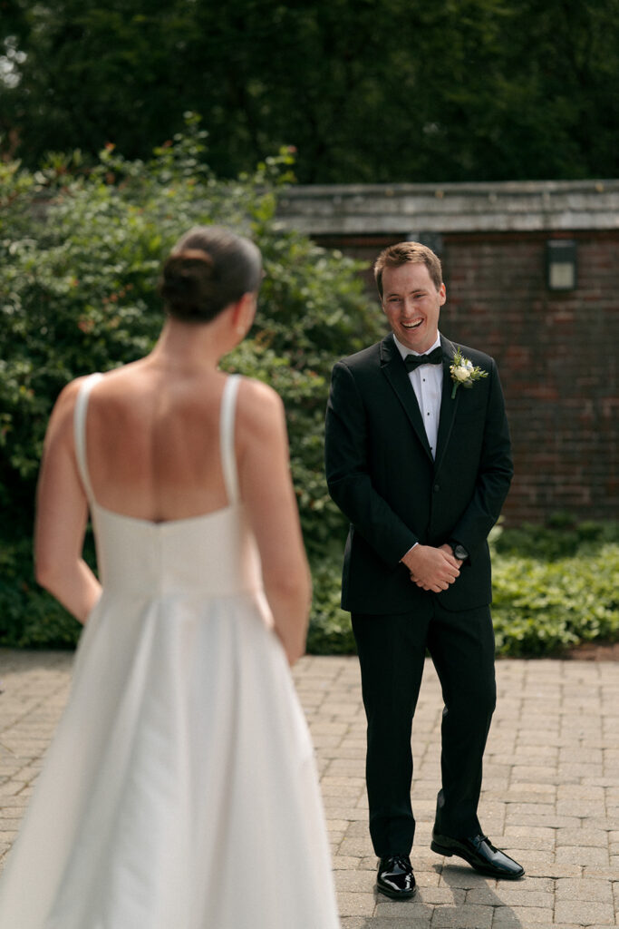 groom emotional seeing the bride in her wedding dress