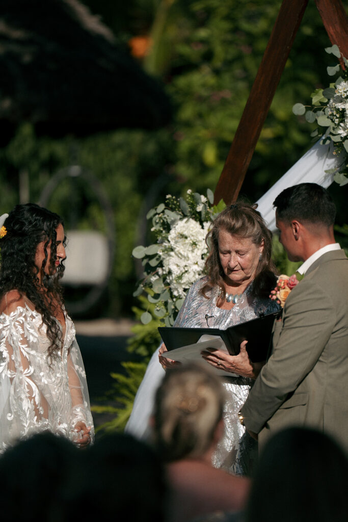 bride and groom holding hands during their ceremony