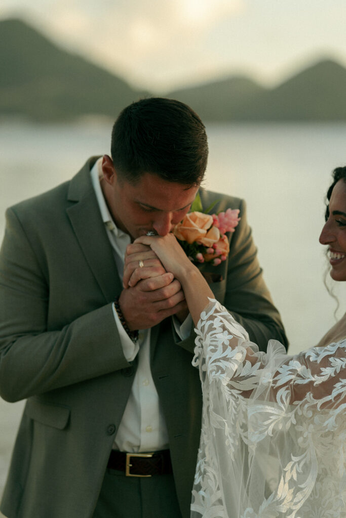 groom kissing the brides hand