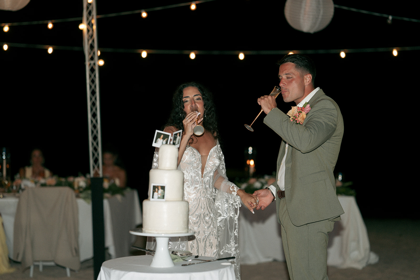 newlyweds trying their wedding cake