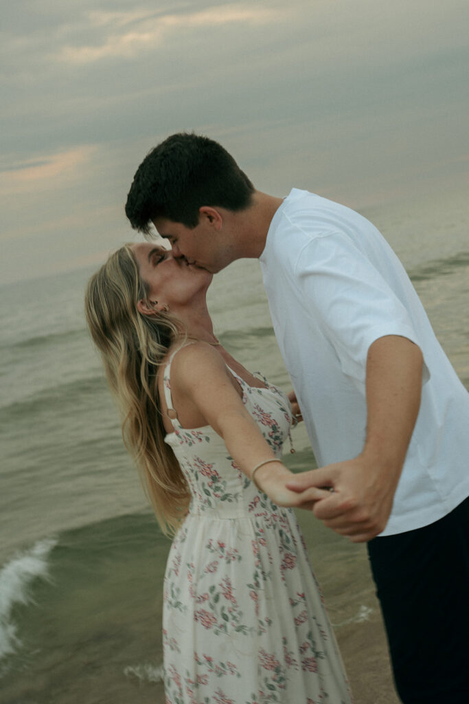 cute picture of the newly engaged couple kissing