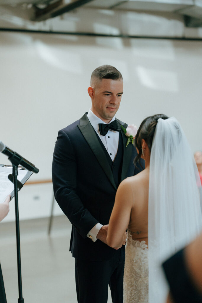 bride and groom, holding hands during their ceremony