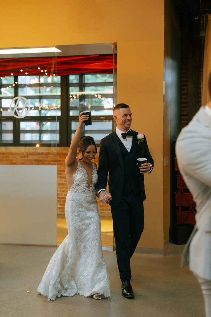 Newly married couple arriving at their reception party