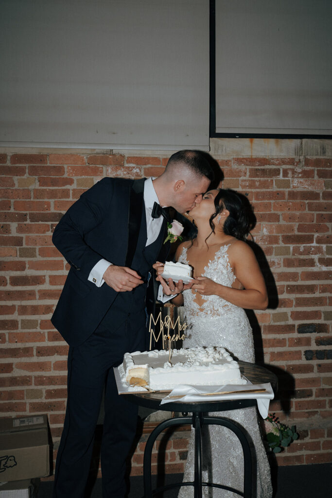 Couple trying their wedding cake