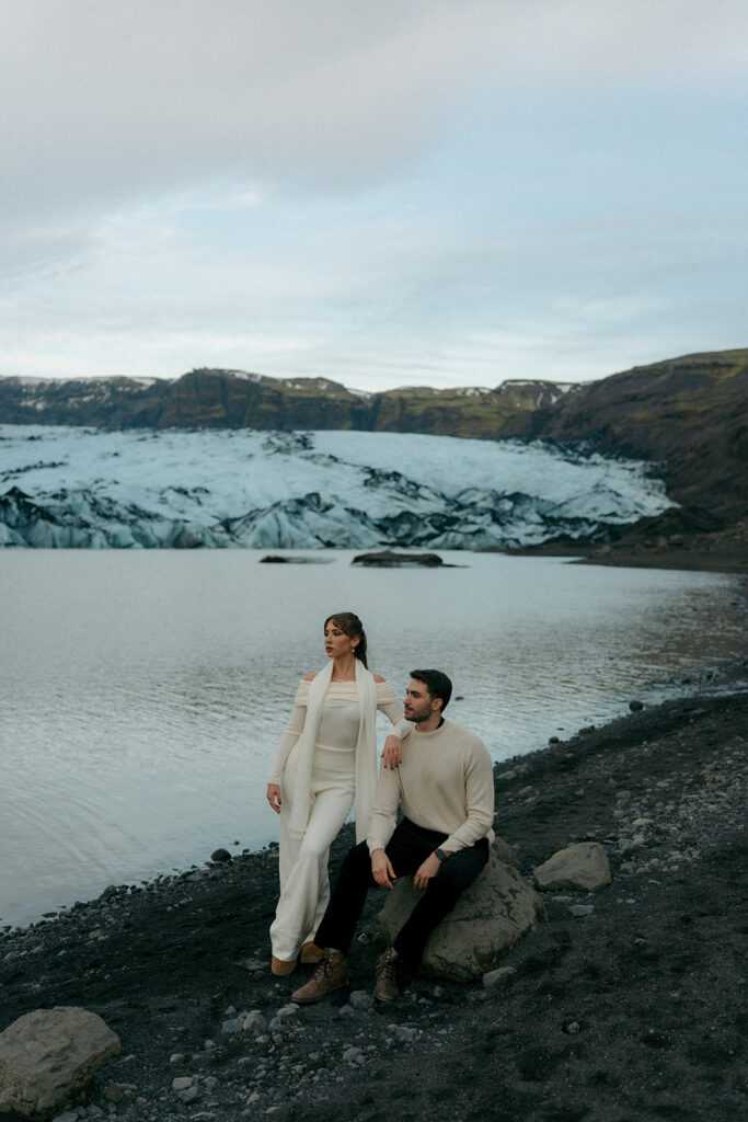 Engaged couple dancing and twirling on white Iceland glacier with dramatic ice peaks in background by Michigan Iceland engagement photographer Cassidy Lynne
