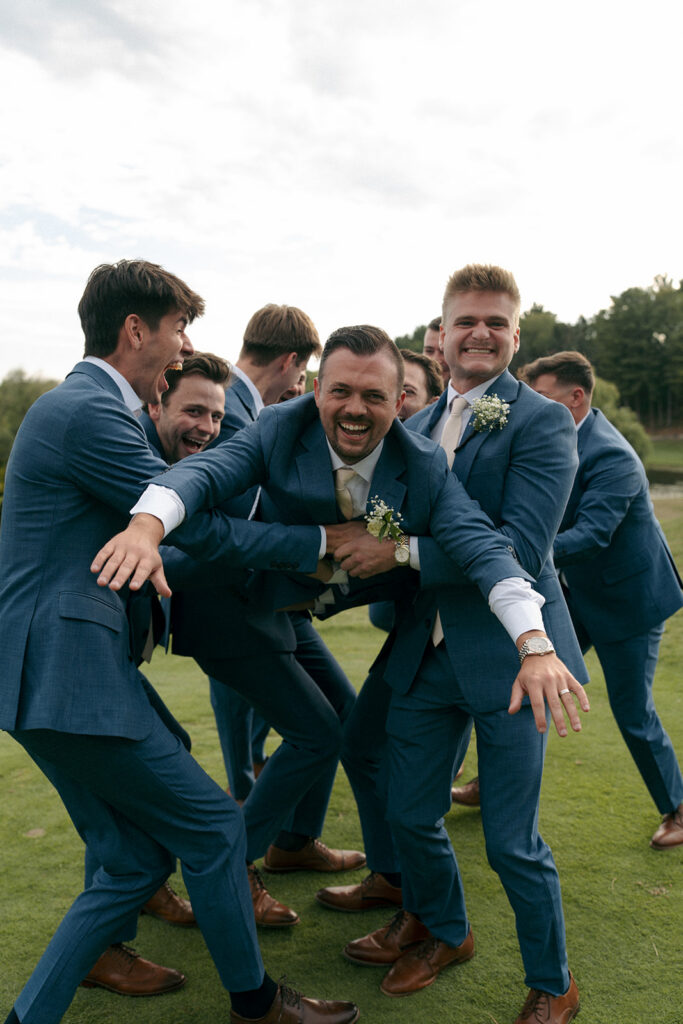 Bride and groom celebrating with guests during cocktail hour at Wabeek Club