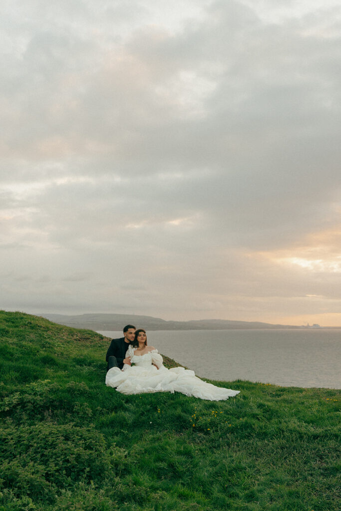Bride in flowing wedding dress on dramatic coastal cliffs elopement photos Fast Castle Edinburgh Scotland