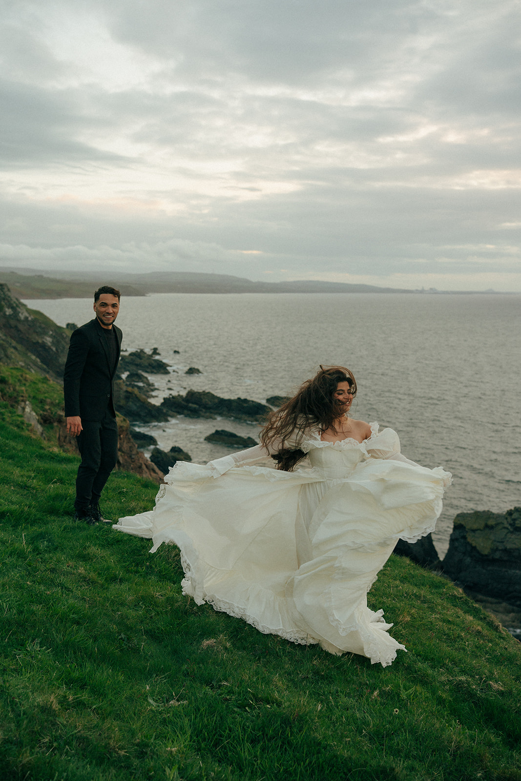 Couple embracing during cliffs elopement photos at Fast Castle near Edinburgh Scotland