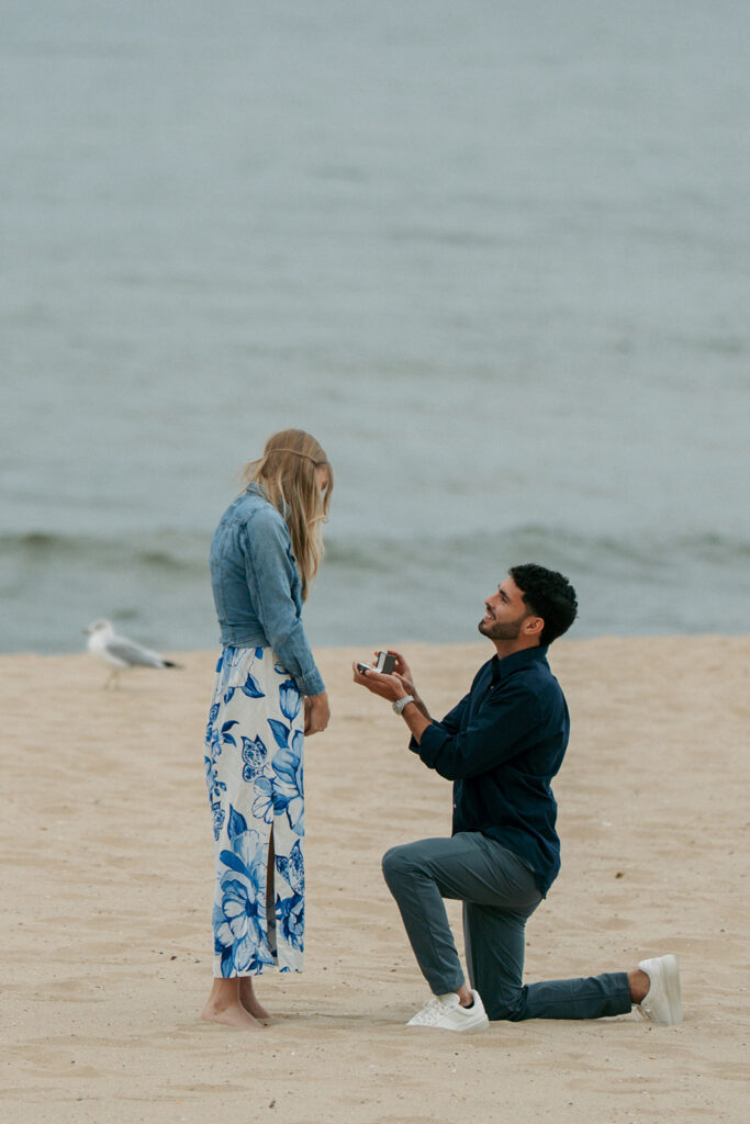 Engagement ring closeup with Lake Michigan sunset at Oval Beach Saugatuck