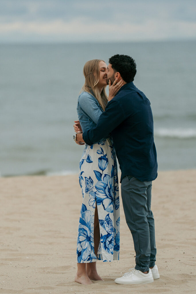 Happy couple laughing together during engagement session at Oval Beach Michigan