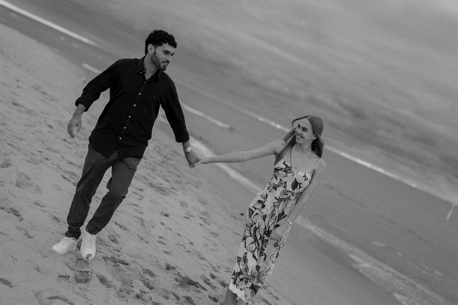 Engagement ring detail shot with Oval Beach sand and waves in background