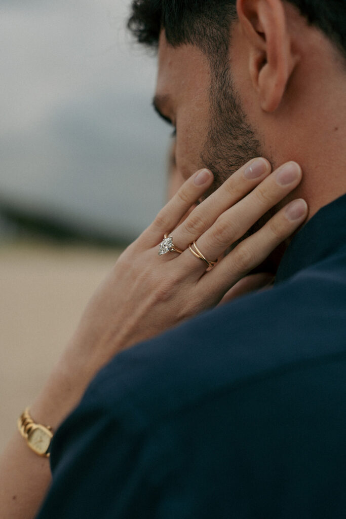Intimate forehead touch moment between newly engaged couple at Oval Beach Michigan
