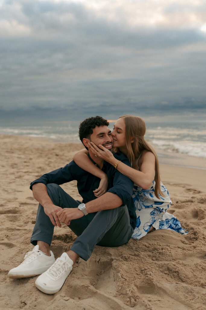 Close up of engagement ring with Lake Michigan waves in background at Oval Beach