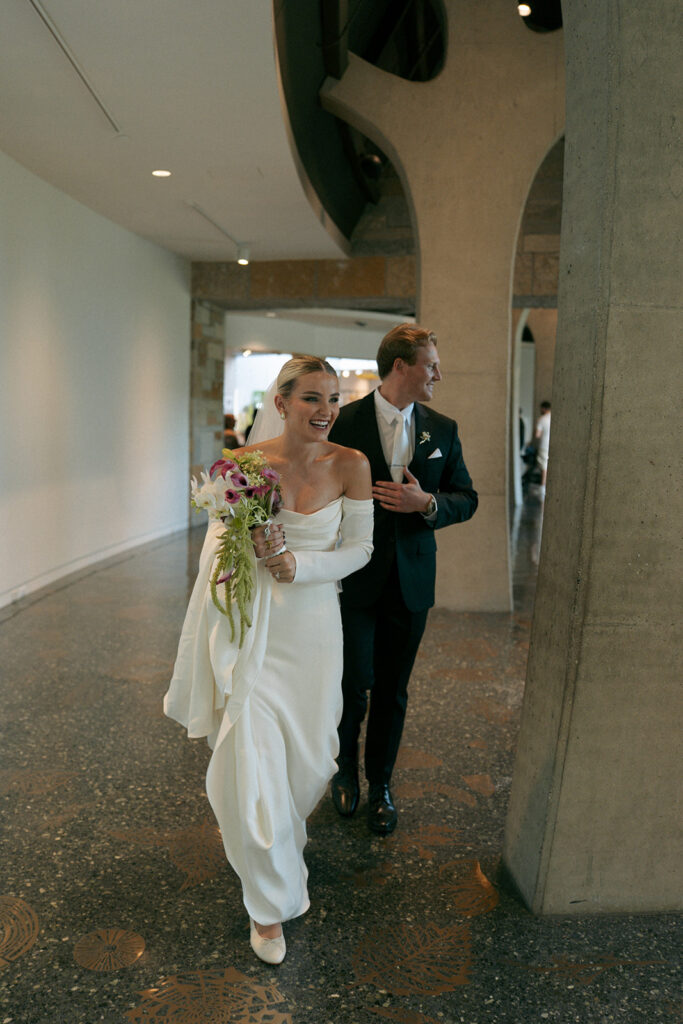 Bride and groom kiss under garden arbor at Meijer Gardens Michigan