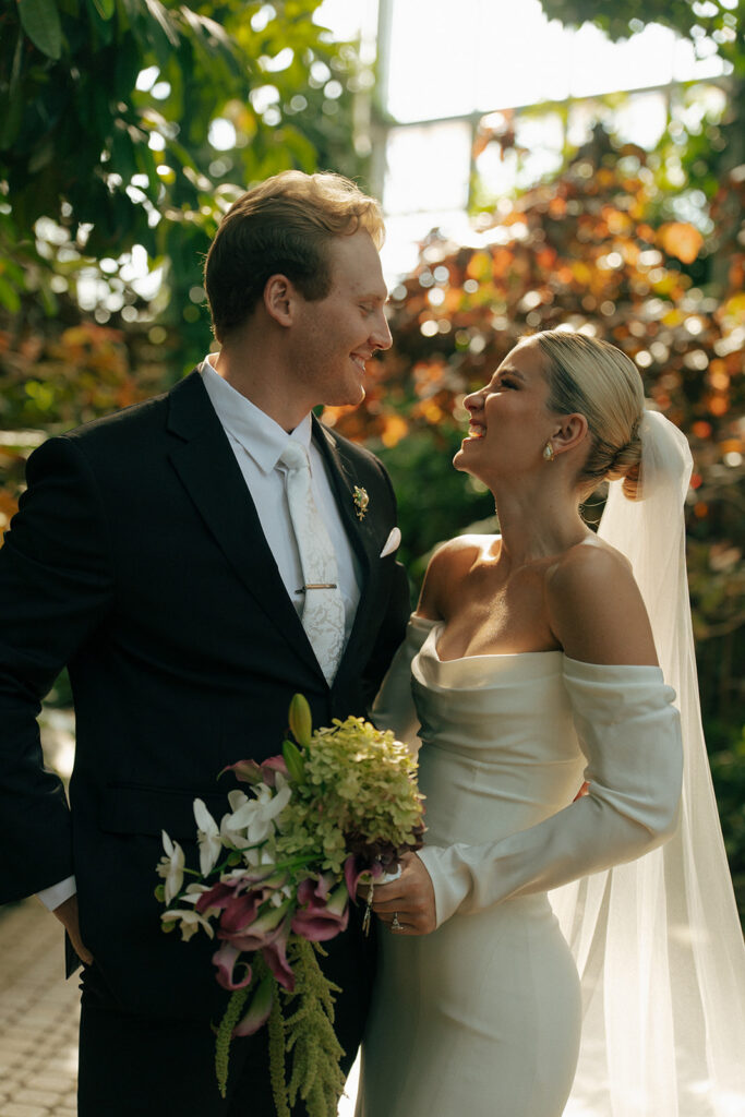 Bride and groom portrait with conservatory backdrop at Fredrick Meijer Gardens wedding