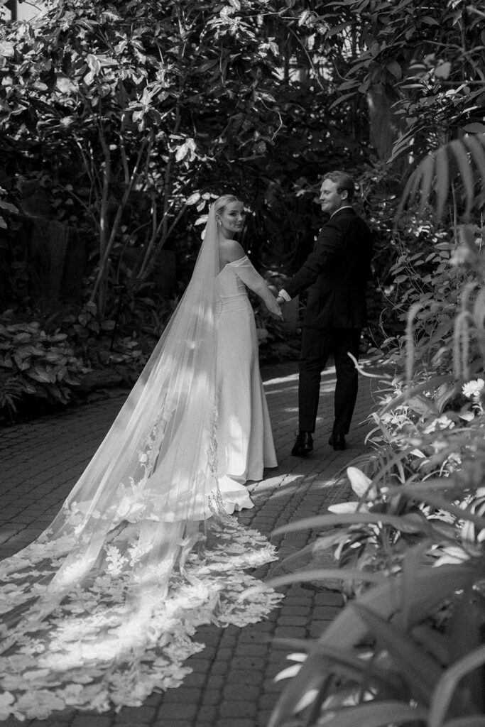 Bride and groom exchanging vows during outdoor wedding ceremony at Fredrick Meijer Gardens in Grand Rapids