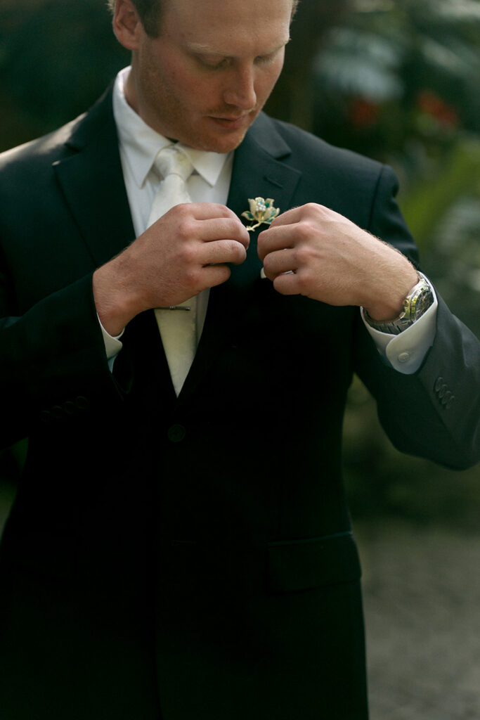 Bride holding elegant white floral bouquet at Fredrick Meijer Gardens wedding