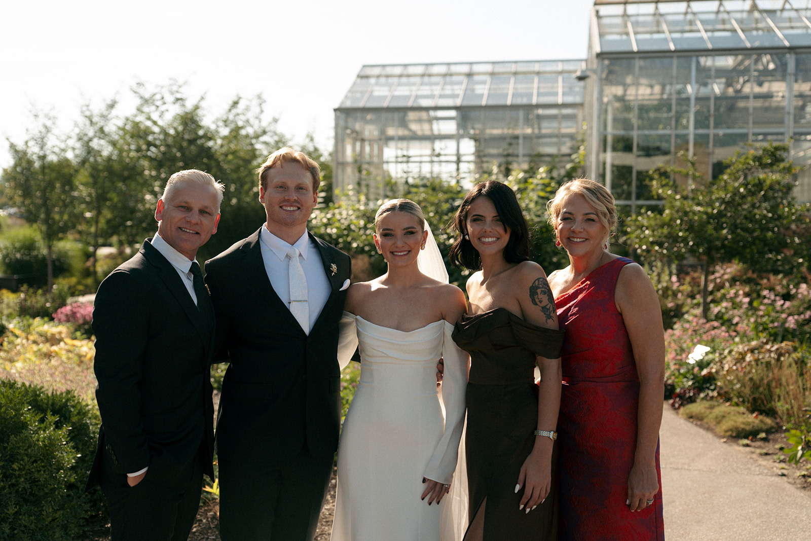 Groom dipping bride for kiss in greenhouse conservatory at Grand Rapids Michigan wedding