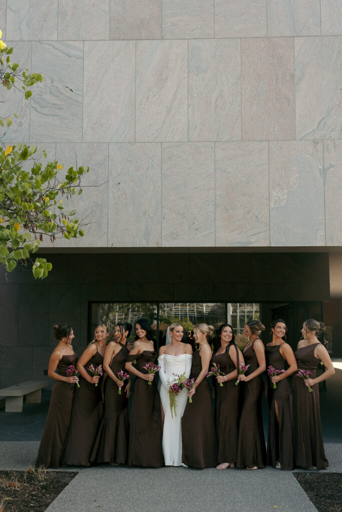 Bride and groom sharing intimate moment in lush garden conservatory at Fredrick Meijer Gardens wedding