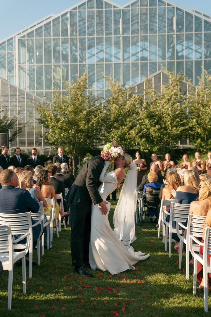 Bride hugging family member during receiving line at Grand Rapids garden wedding